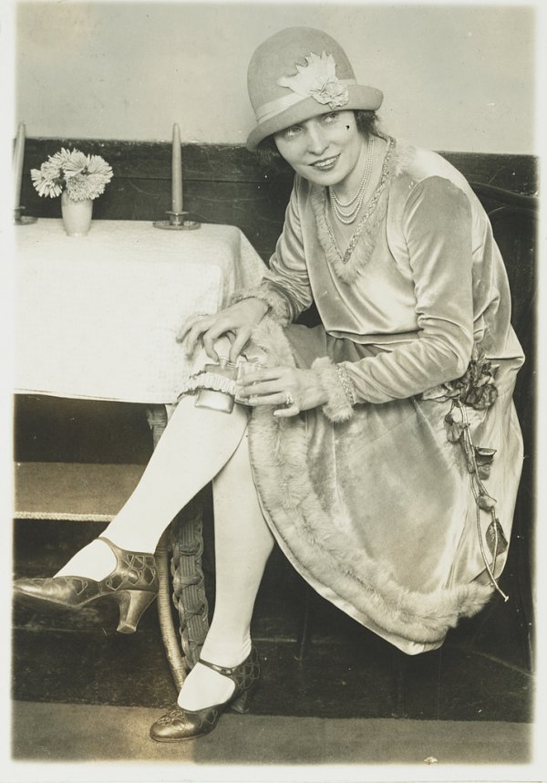 Image: 1926 photo of a woman showing the garter flask fad during Prohibition. From the Library of Congress.